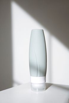 A minimalistic skincare product tube illuminated by natural daylight, emphasizing purity and elegance.