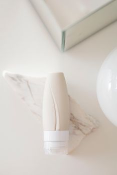 Minimalist skincare tube placed on marble, perfect for beauty and packaging themes.