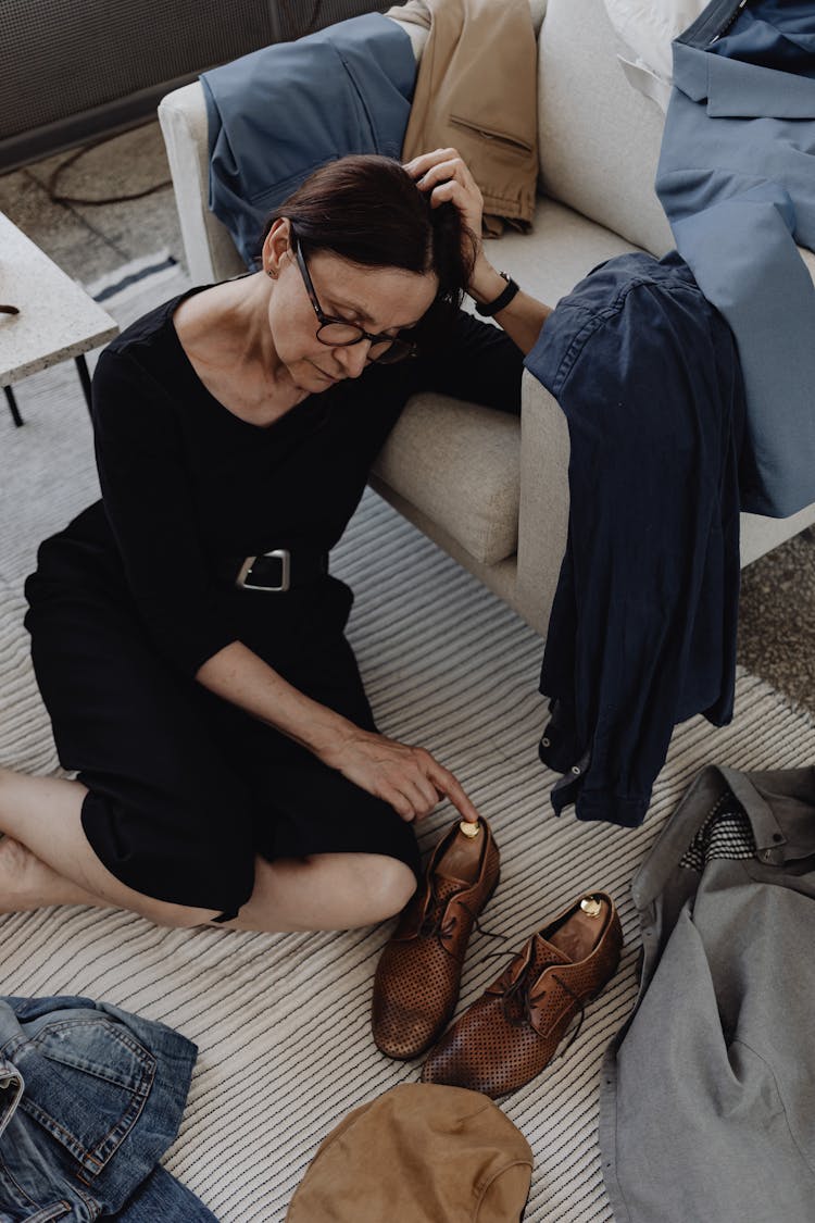 A Sad Woman Sitting On The Floor