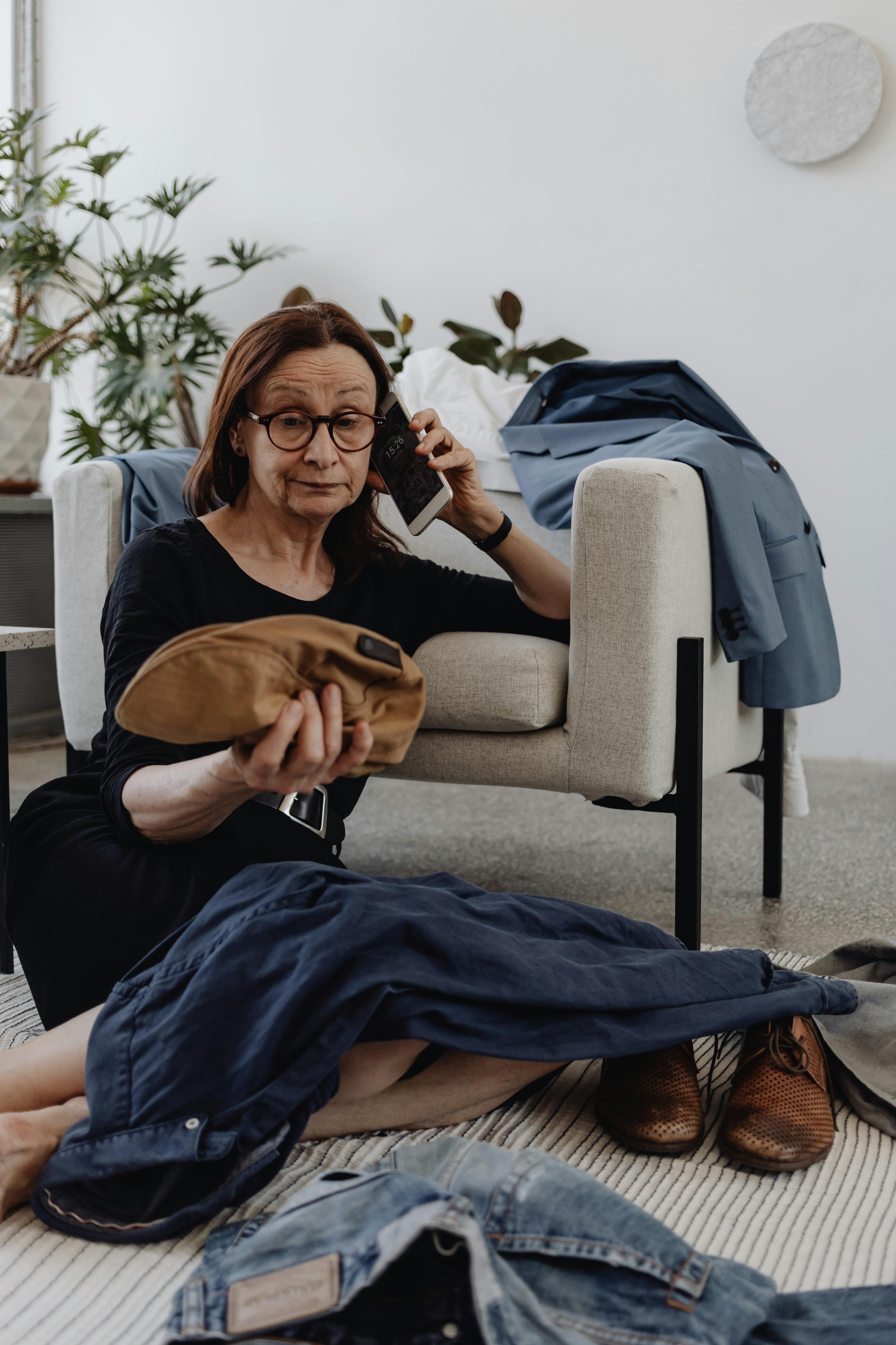 A Woman Talking on the Phone while Sitting on the Floor · Free Stock Photo