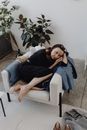 Man in Black Jacket Sitting on White Couch