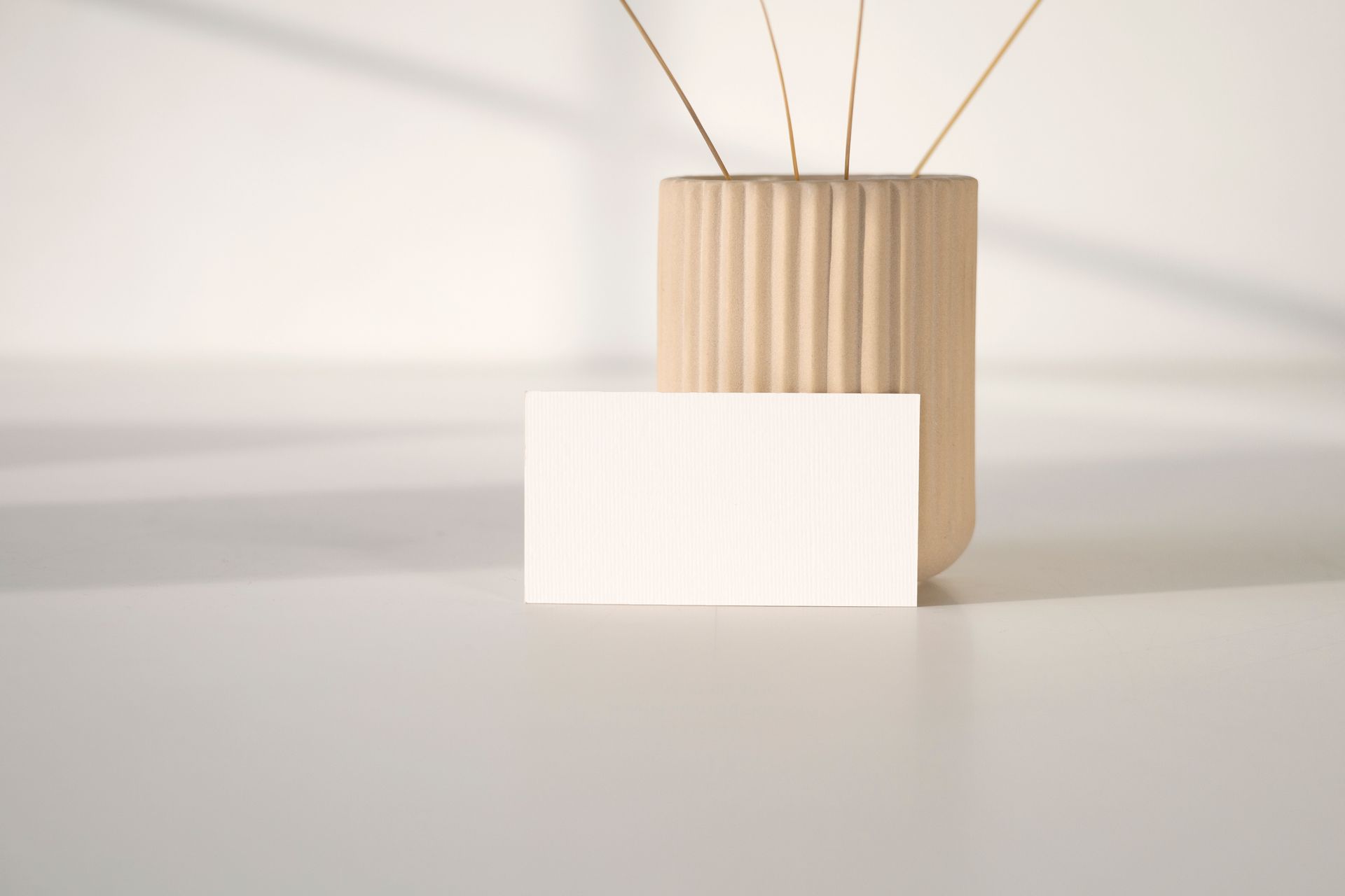 White Card leaning on a Small Container