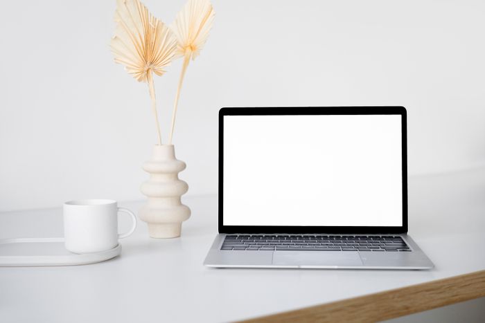 Laptop and coffee on a bright desk — photo by Hanna Pad on Pexels