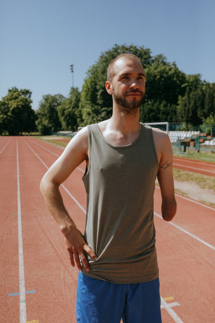 Para Athlete Standing On An Orange Running Track