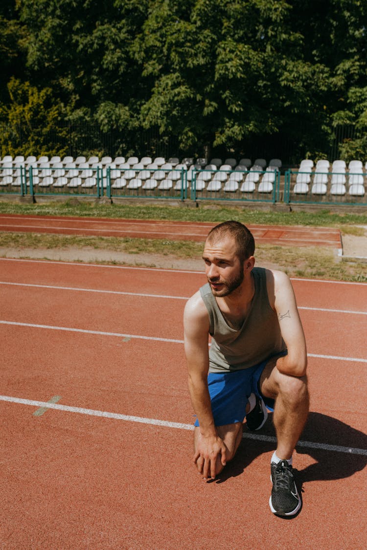 Portrait Of A Para Athlete Kneeling On A Running Track