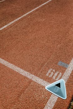 Detailed view of a running track with lane markings and a triangular lane marker.