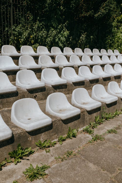 Rows of Old Plastic Seats in Concrete