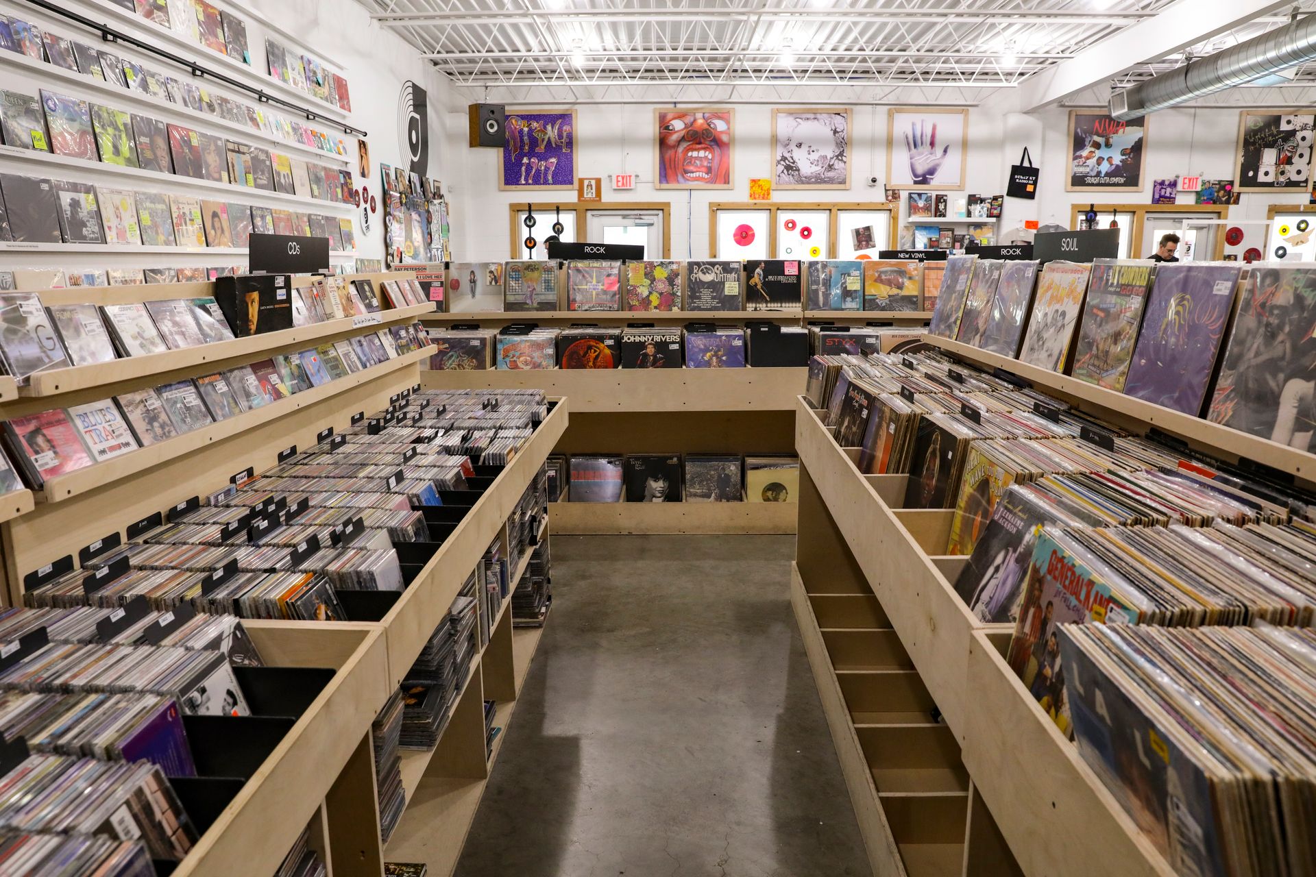Explore a classic record store in Tulsa featuring vinyl and CDs on wooden shelves in a modern layout.