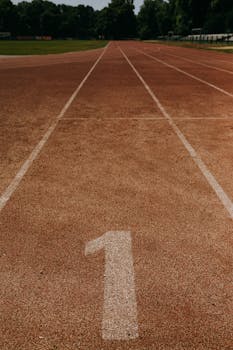 Close-up view of a track lane marked with the number one in an outdoor sports field.