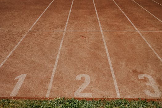 Outdoor sports track with lanes numbered 1 to 3, ready for an athletic event.