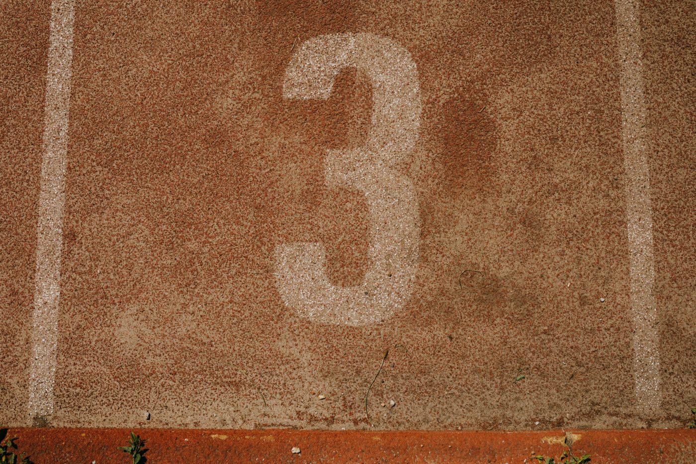 Running track lane marking used for durability and traction testing on both running shoes