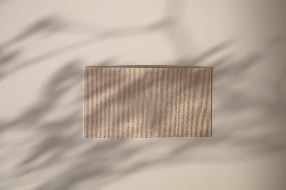 Free Brown Rectangular Board on White Textile Stock Photo