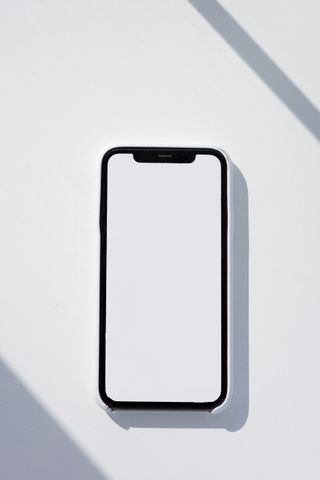 A smartphone lying on a white surface