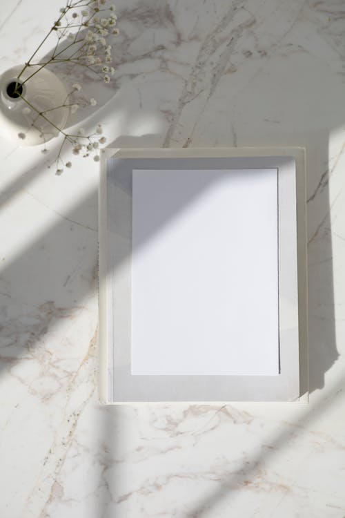 White Wooden Frame a Marble Surface