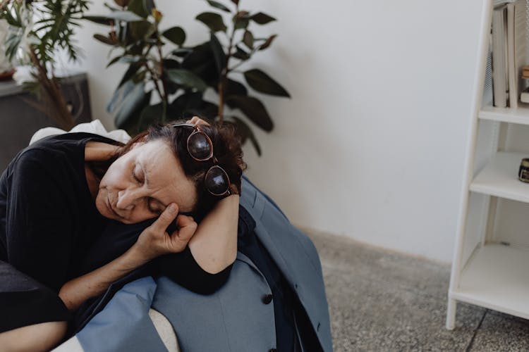 Sad Woman Leaning On A Blue Blazer On A Couch