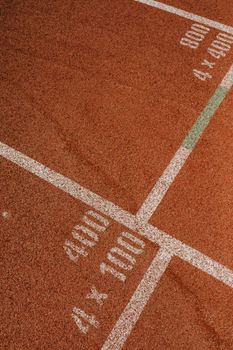 Detailed view of start lines on an athletic running track, perfect for sports themes.