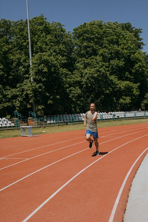 Man Running on Athletics Stadium