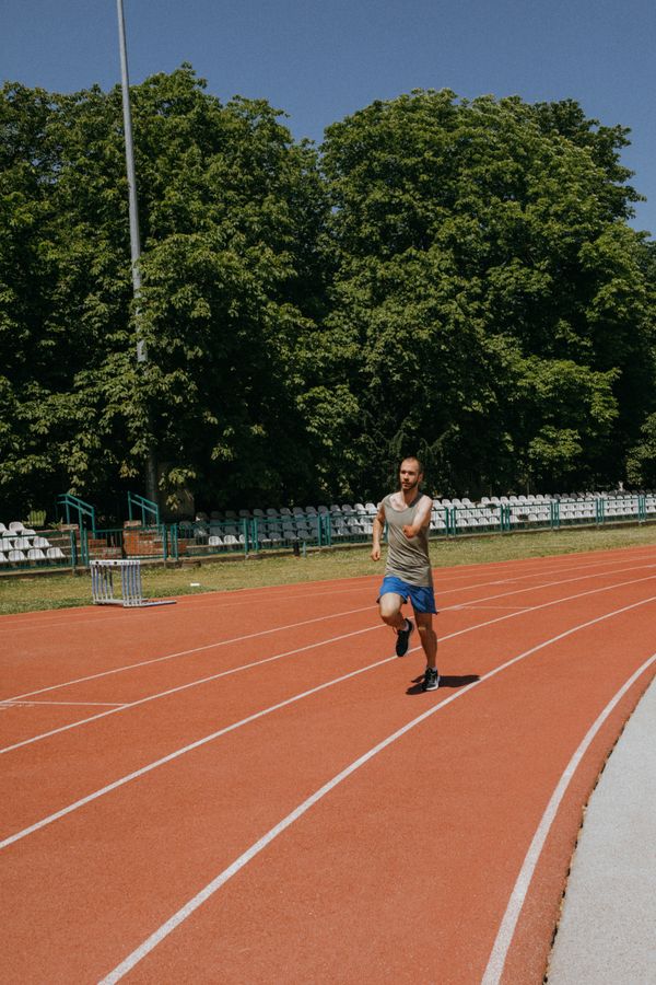 Man running on athletics stadium