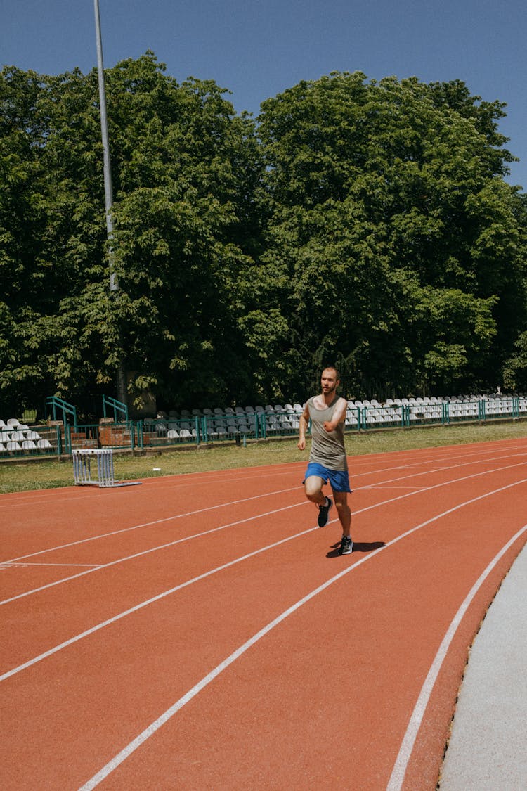 Man Running On Athletics Stadium