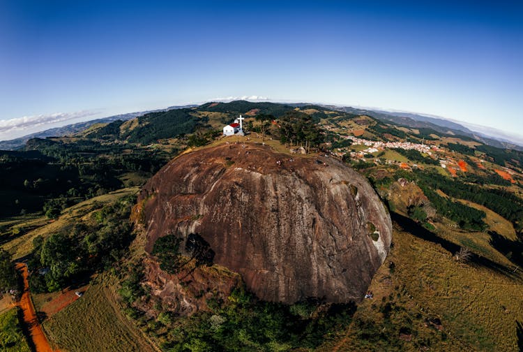 Chapel On Hill Against Forest And Village