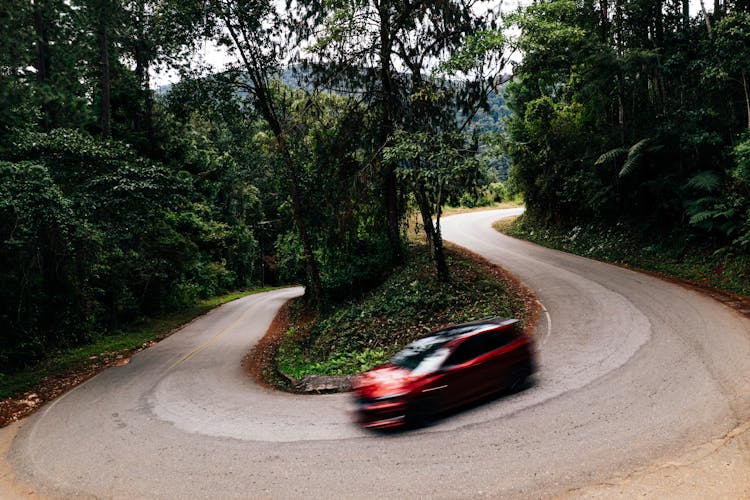 Car Driving On Road Bend In Forest