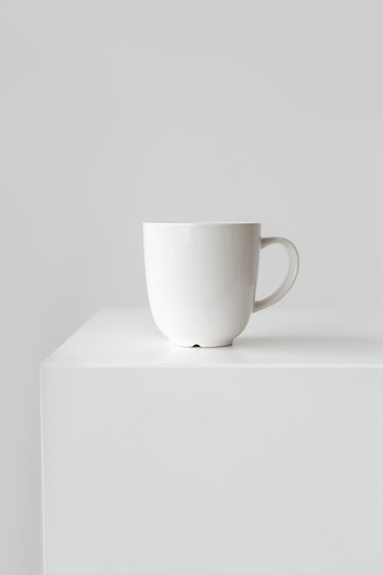 White Ceramic Mug On A White Plinth