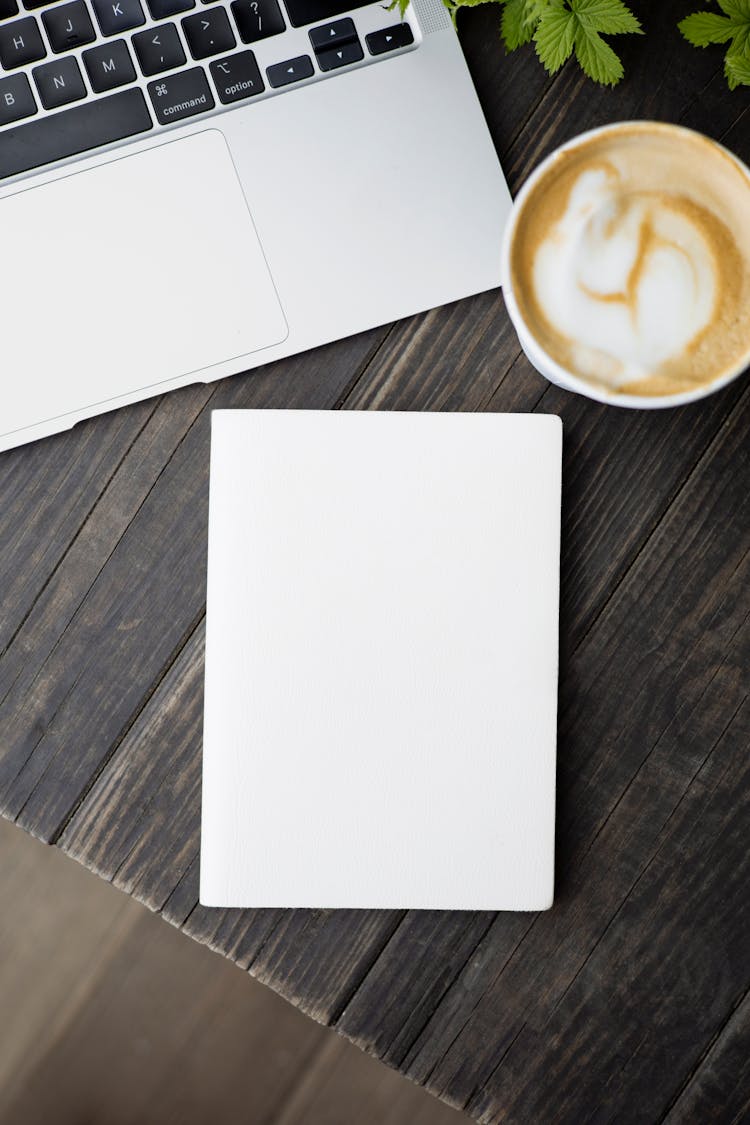 Blank Cover Of A Book Near A Laptop And Coffee