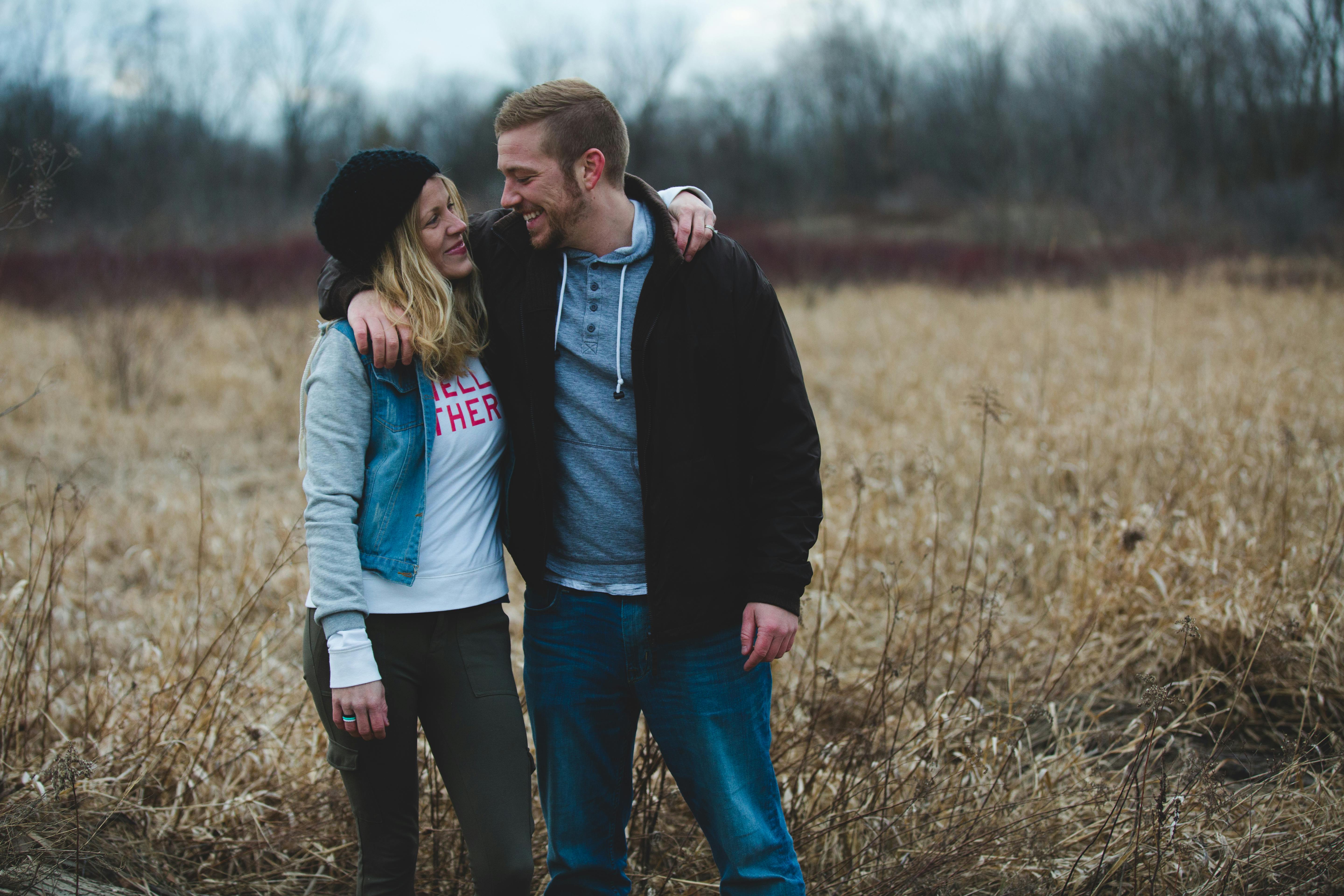 A woman and a man smiled at each other near the field. | Photo: Pexels