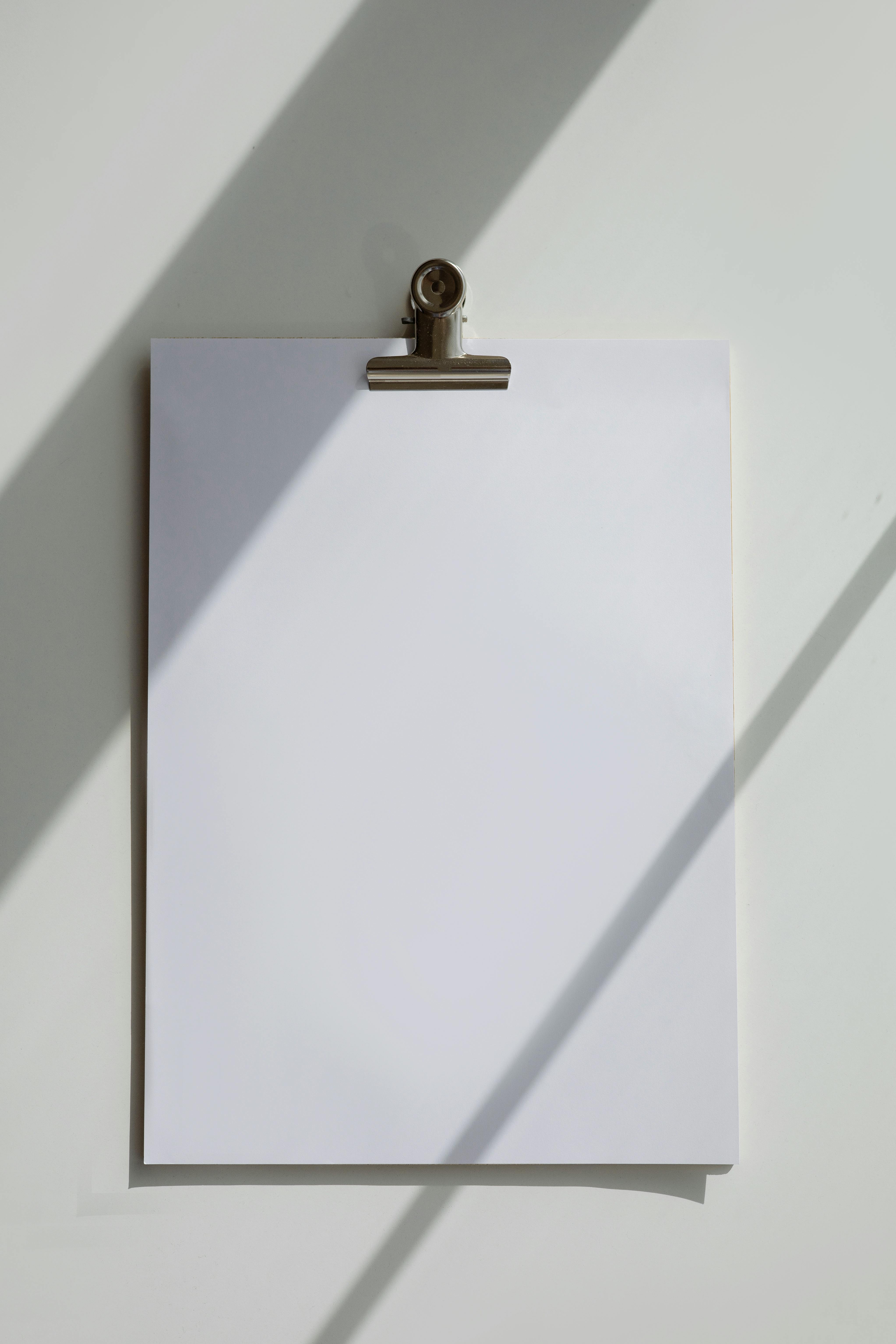 A Blank Bond Paper on a White Surface · Free Stock Photo