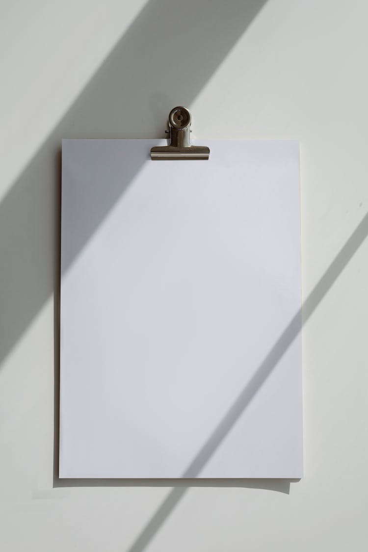 A Blank Bond Paper On A White Surface
