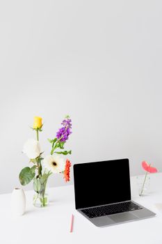 Purple and Yellow Flowers on White Table