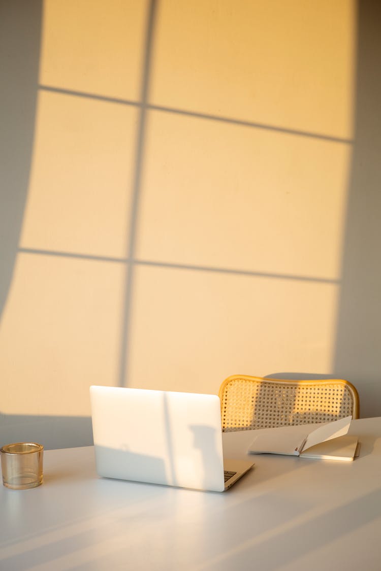 Laptop And Notebook On A White Desk