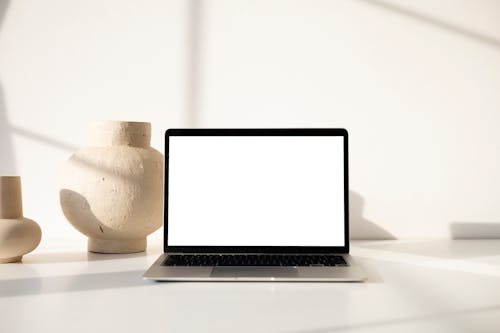 A Laptop and Clay Pots