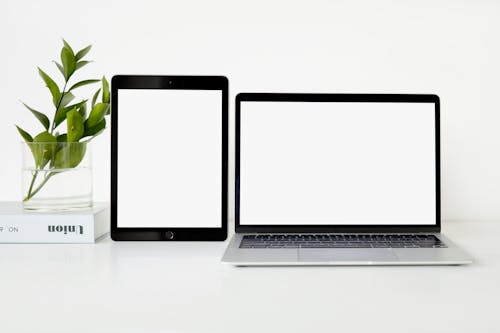 Free Macbook Pro Beside Black Ipad Stock Photo