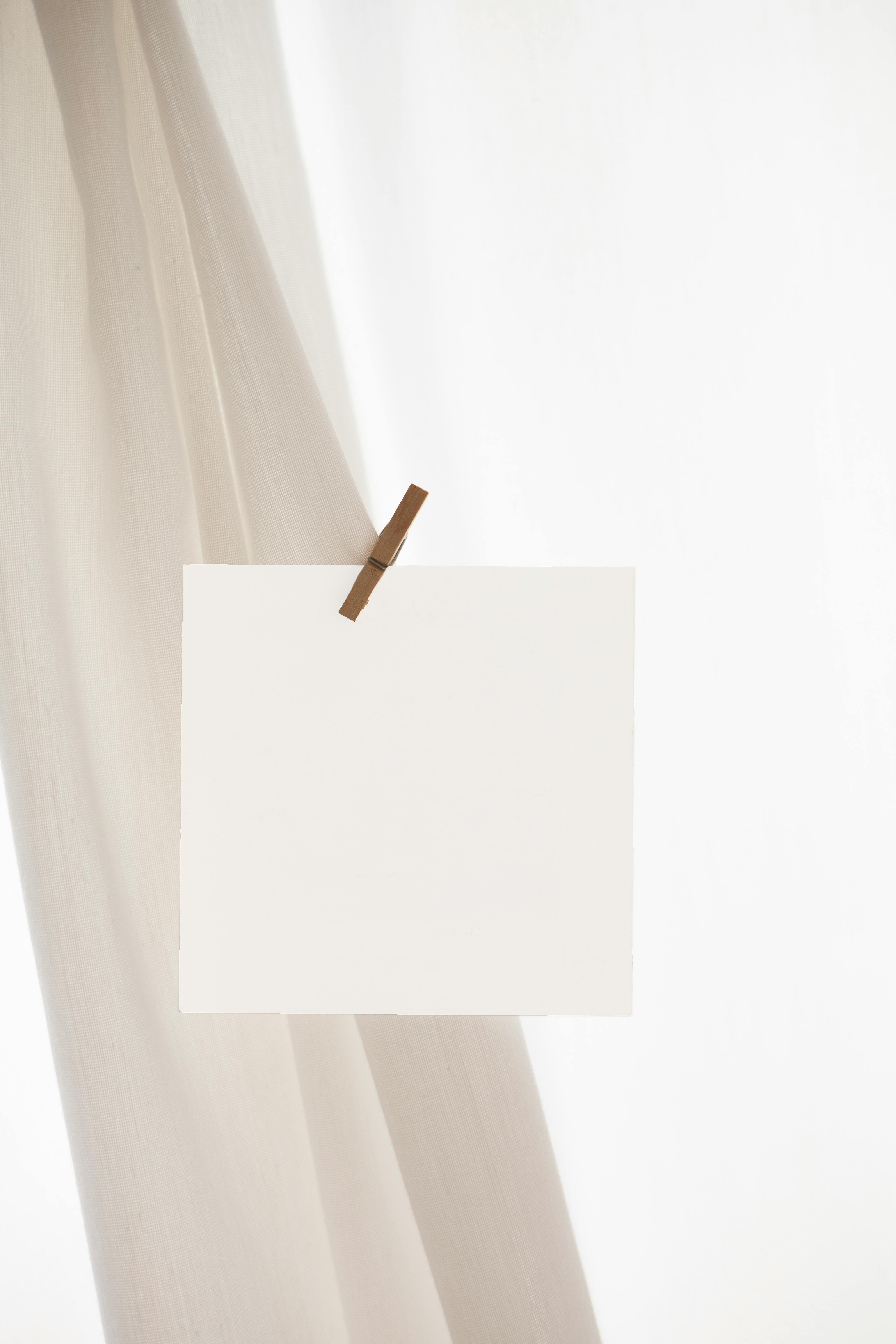 white blank paper on curtain