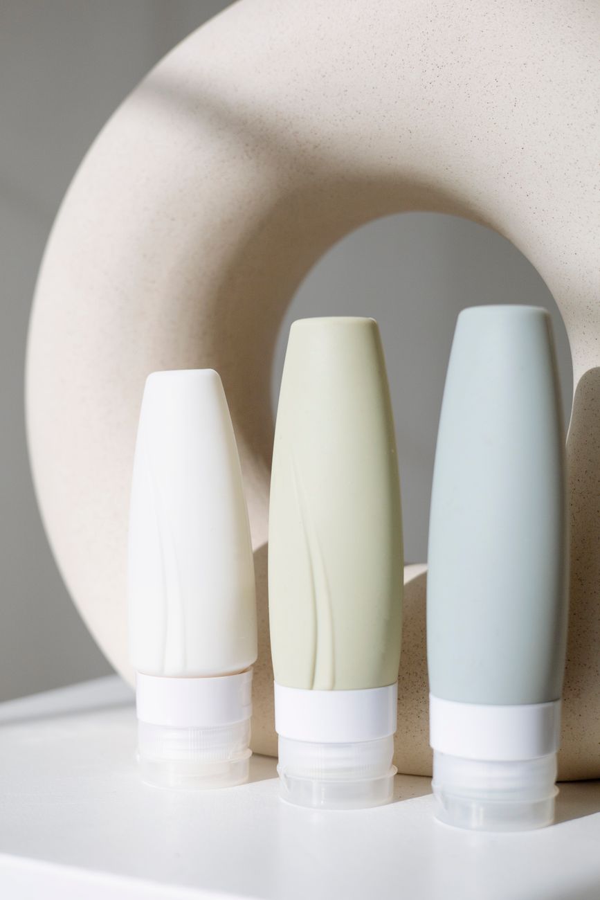 Soft still life of a Vellum & Bloom skincare bottle on a porcelain surface, bathed in natural light