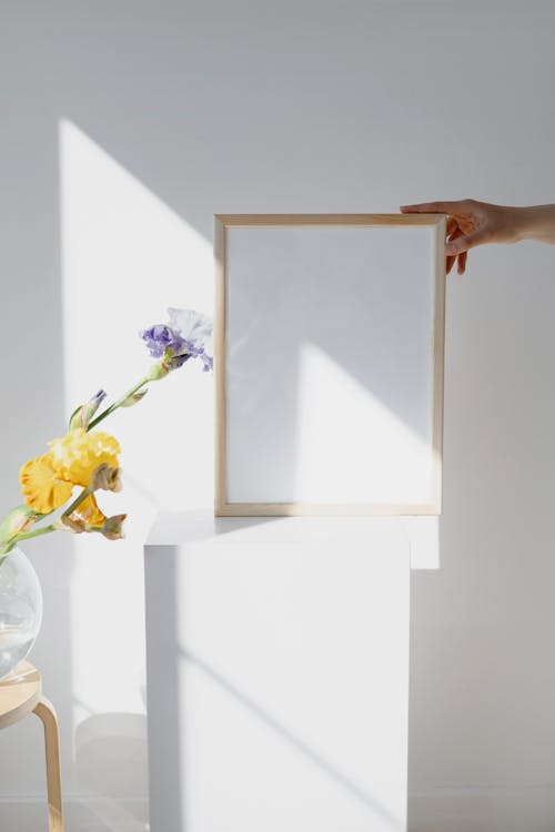 Person Holding a Wooden Picture Frame 