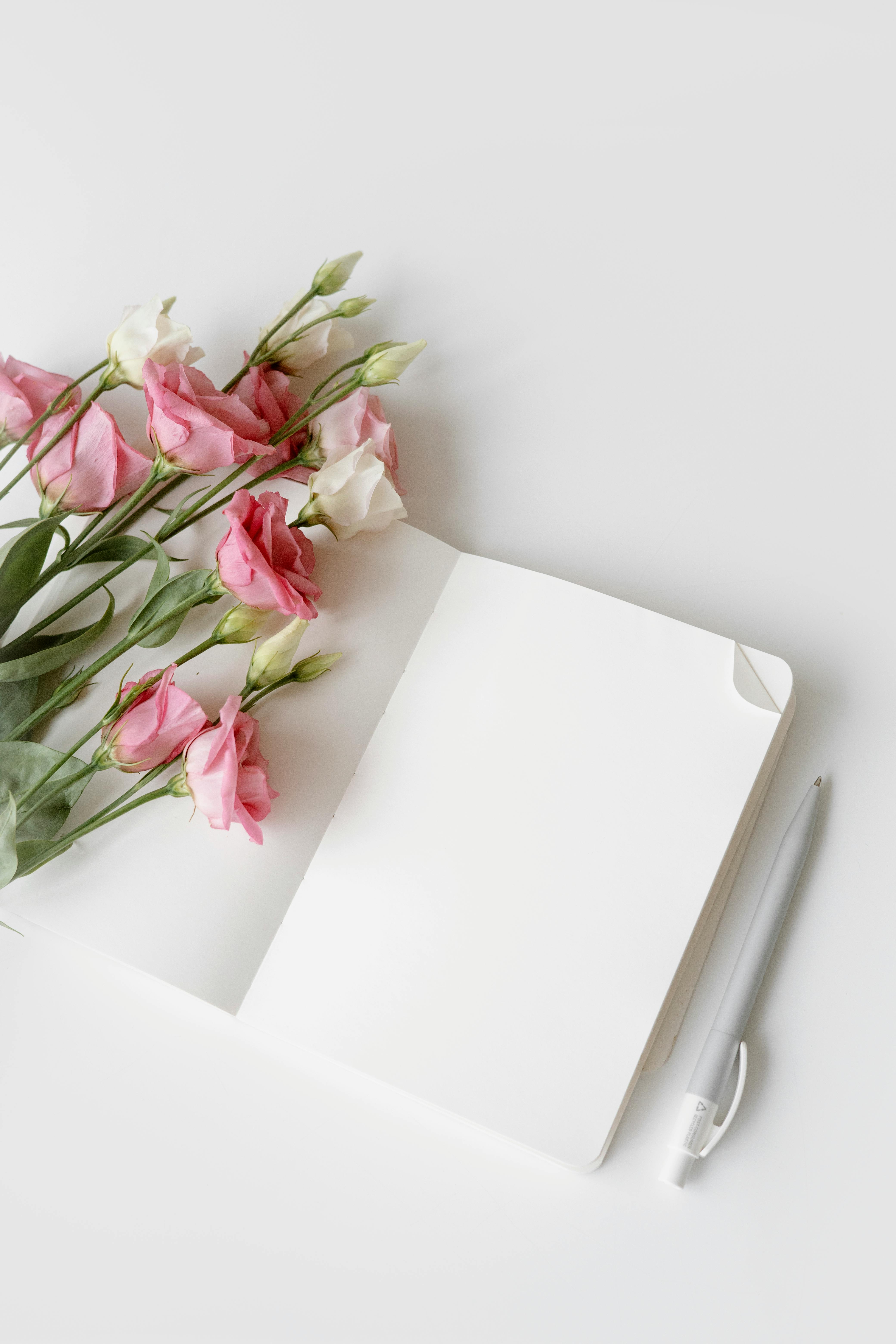 An open blank sketchbook with flowers on a wooden desktop - Buy this stock  photo and explore similar images a…