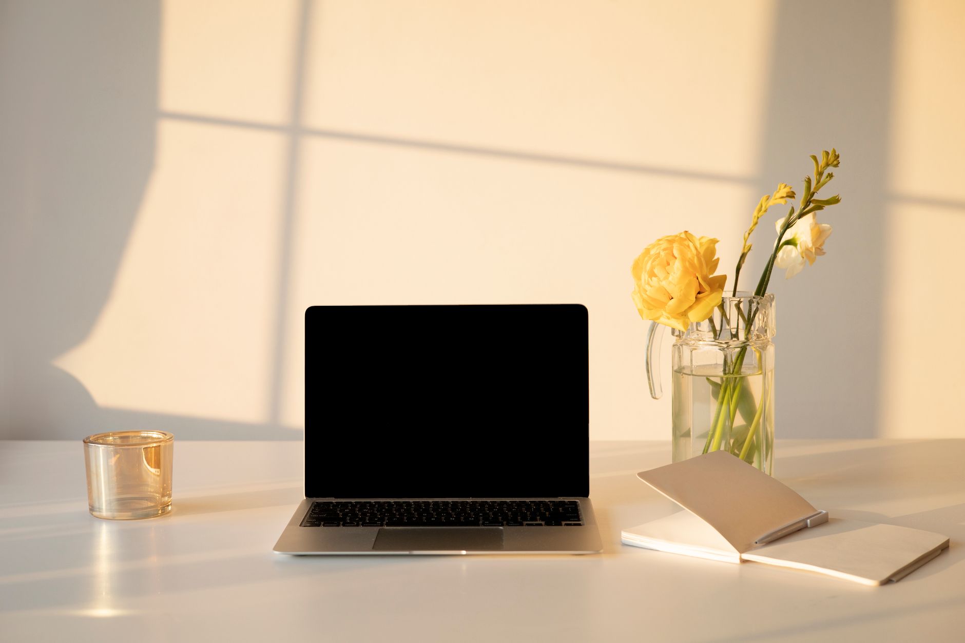 A tidy home office desk with a laptop and notebook in morning light, where the weekly stack maintenance happens