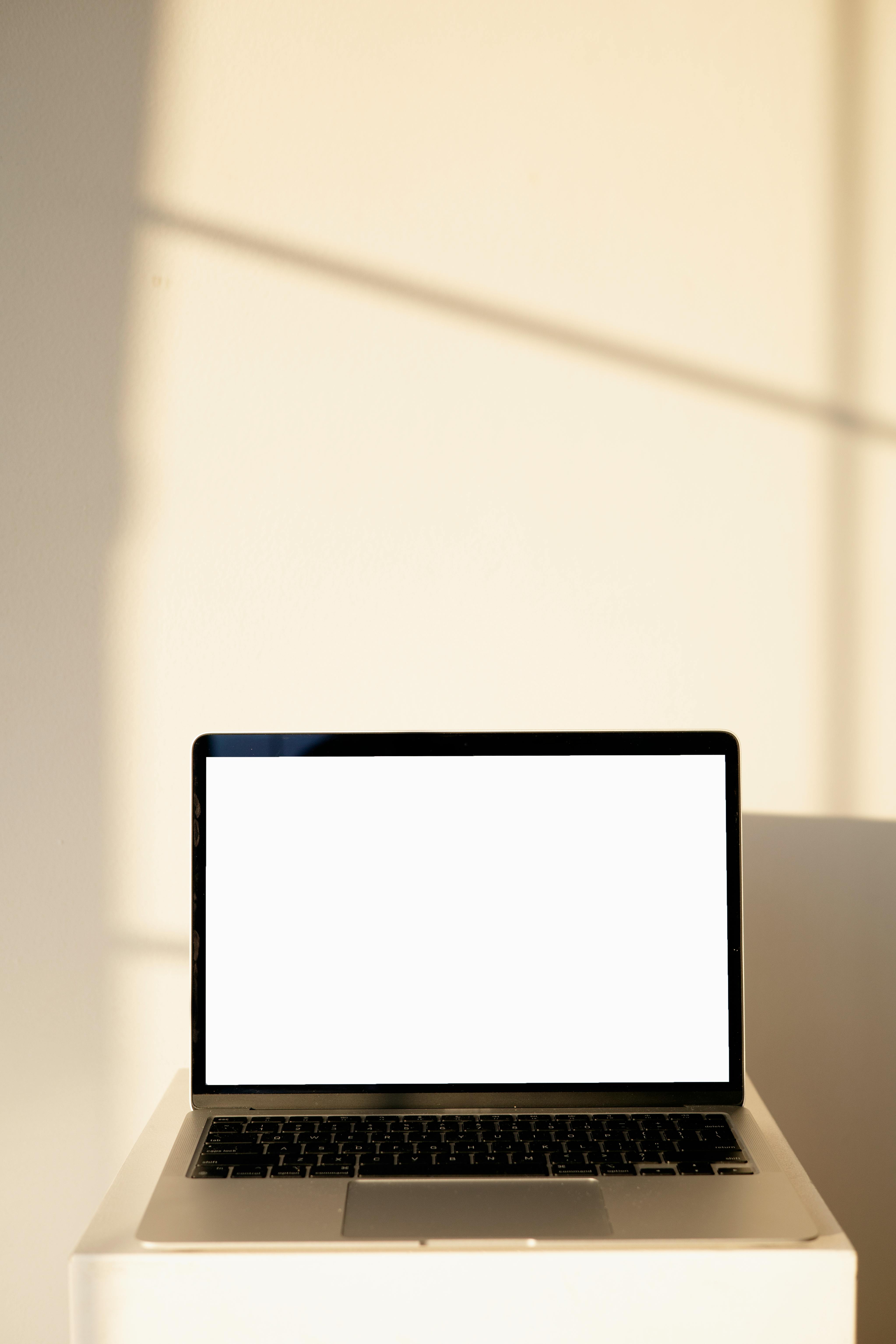 a laptop with a blank white screen