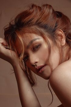 Close-up portrait of a woman with brown hair, showcasing beauty and elegance.