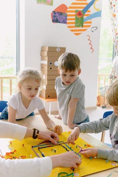 Kids collaborating on a colorful project in a bright kindergarten classroom.