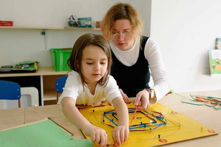 A Woman And A Girl Doing Artworks