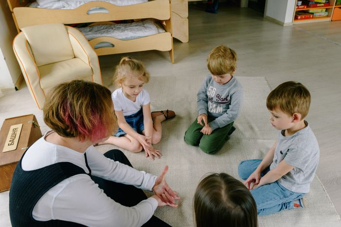 Children in a learning circle with teacher
