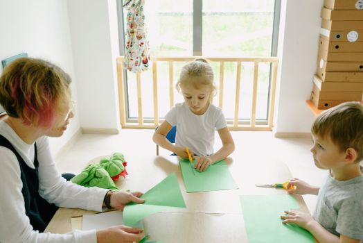 Boy in White Tank Top Sitting on White Table