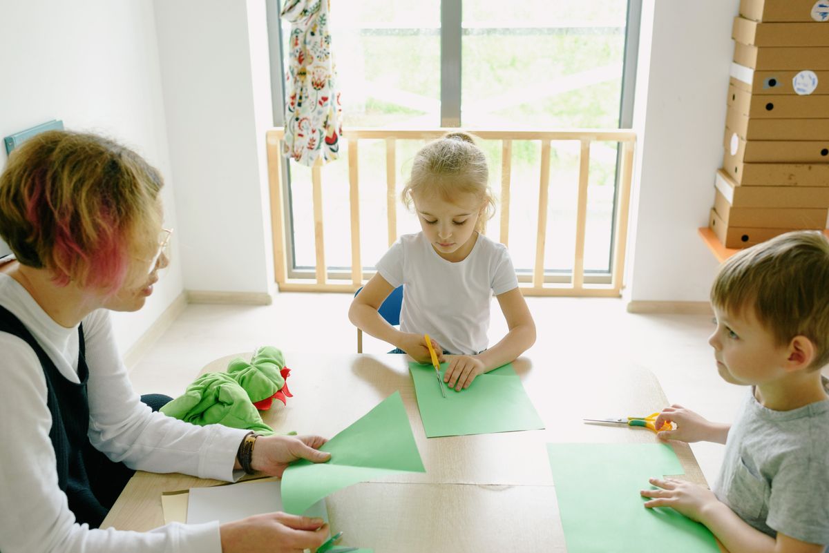 Mother and children cutting paper for paper plate crafts for kids