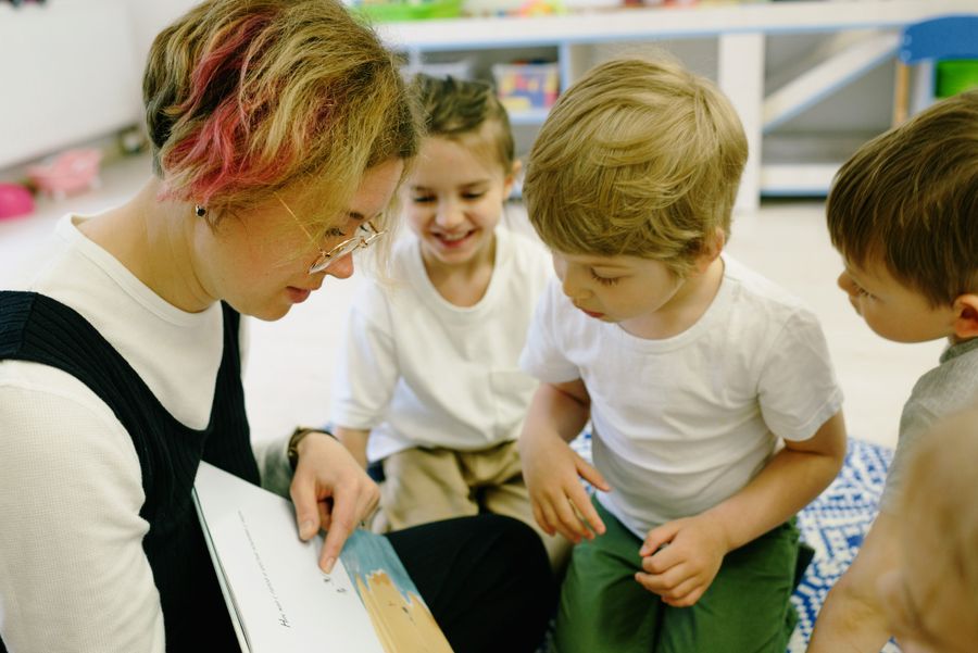 A volunteer reading with children