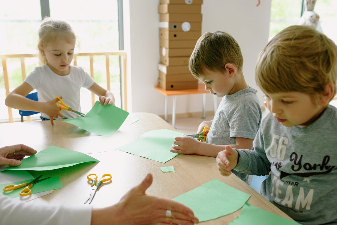 Free A Boys and Girl Cutting the Paper Stock Photo