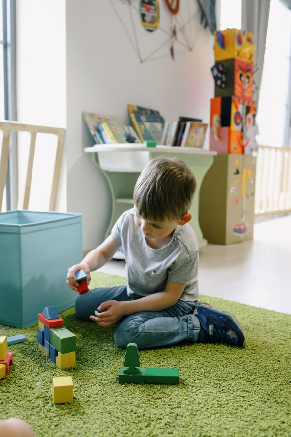 Young child playing with colorful building blocks