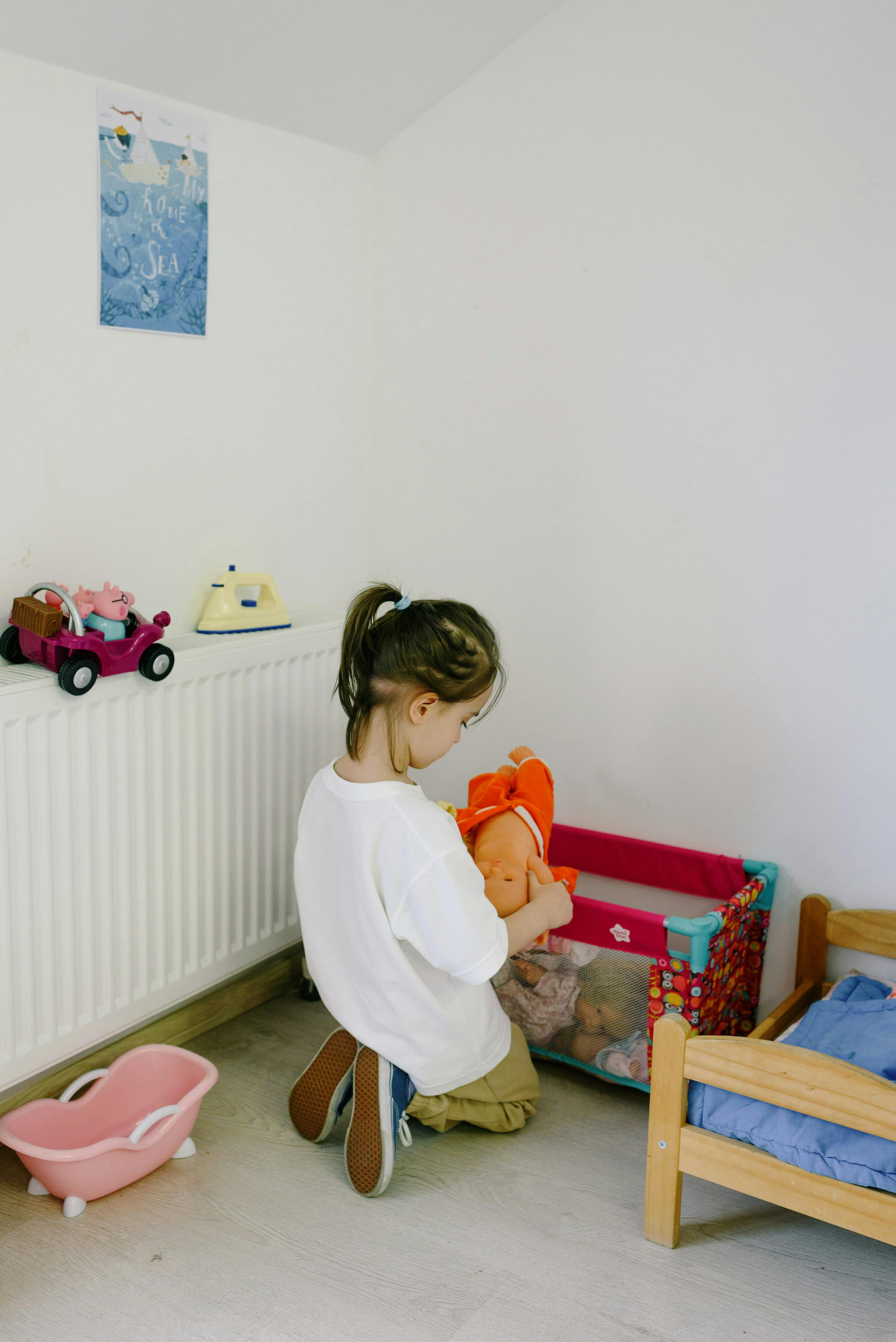 a girl playing a doll